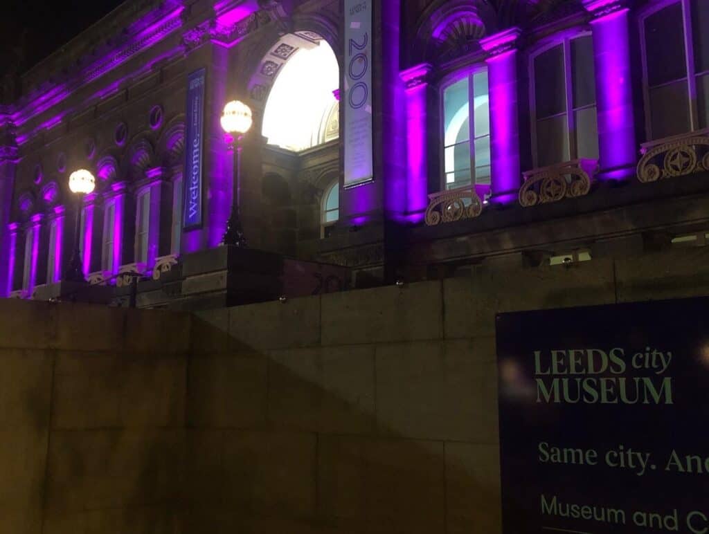 Leeds City museum lit up purple