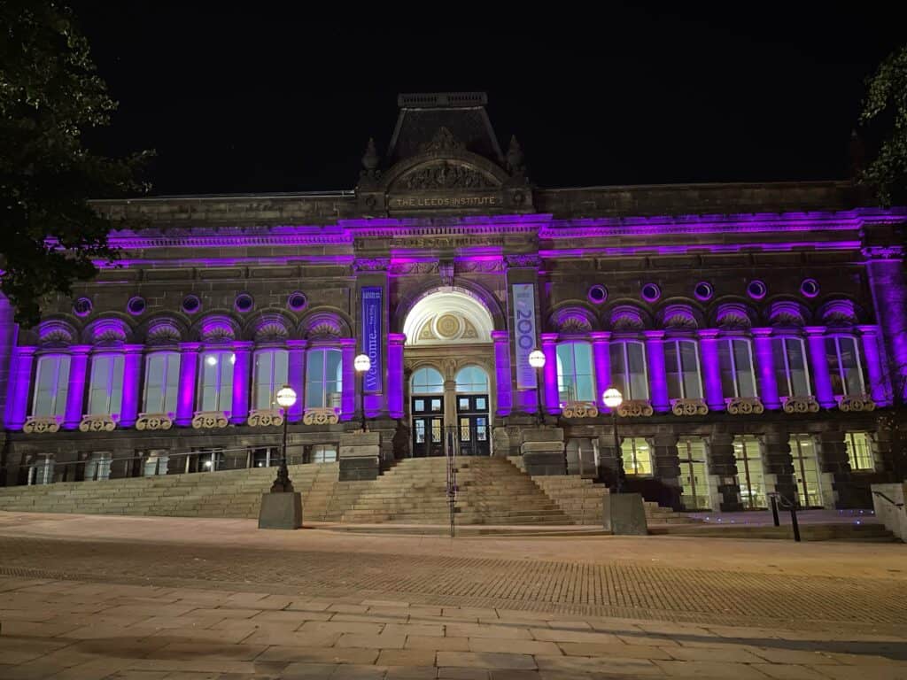 Building lit up at night with purple lights