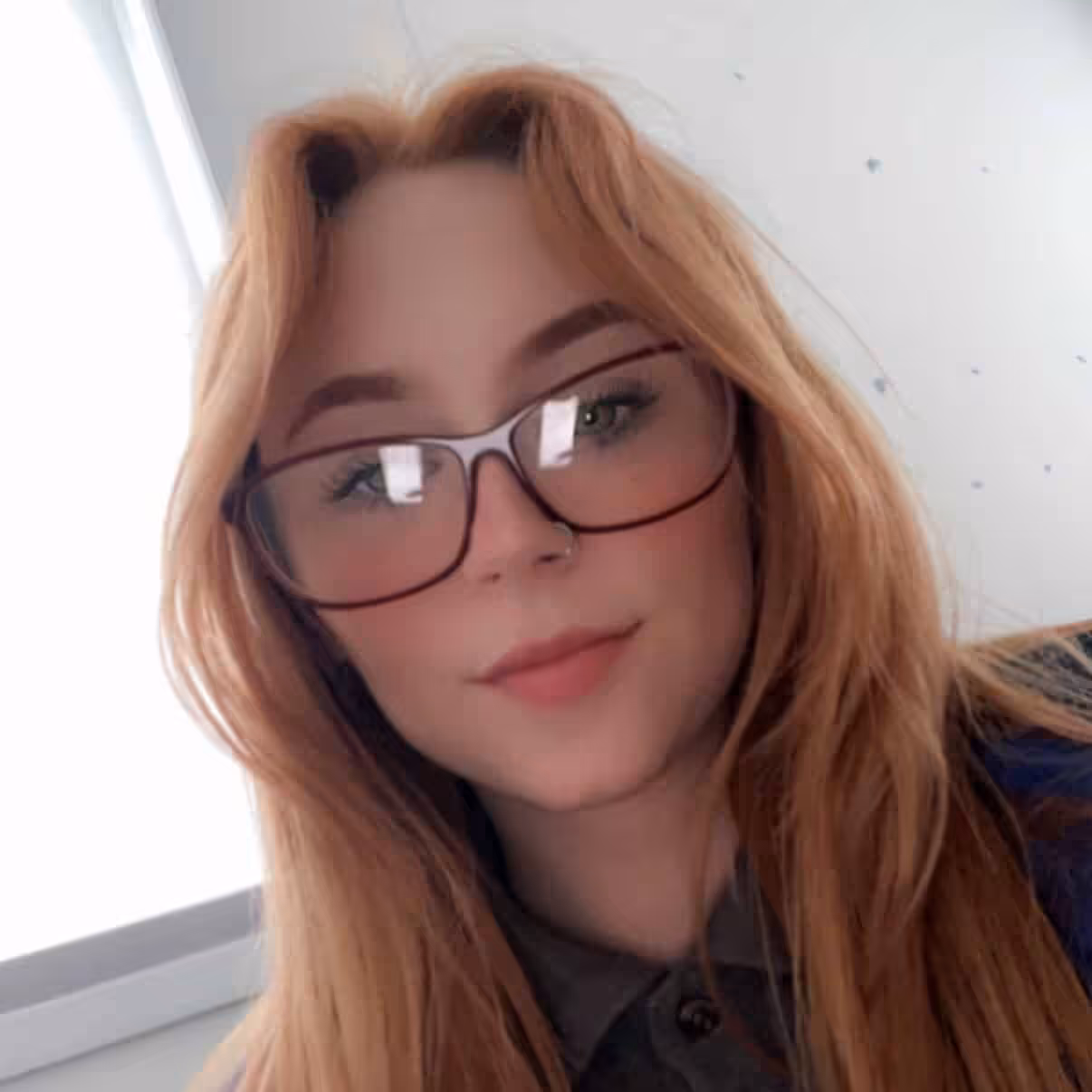 Female wearing glasses looking toward camera
