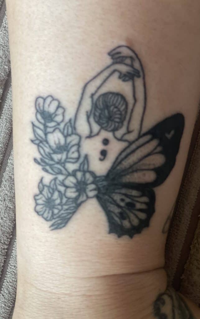 Tattoo of a woman with butterfly wings