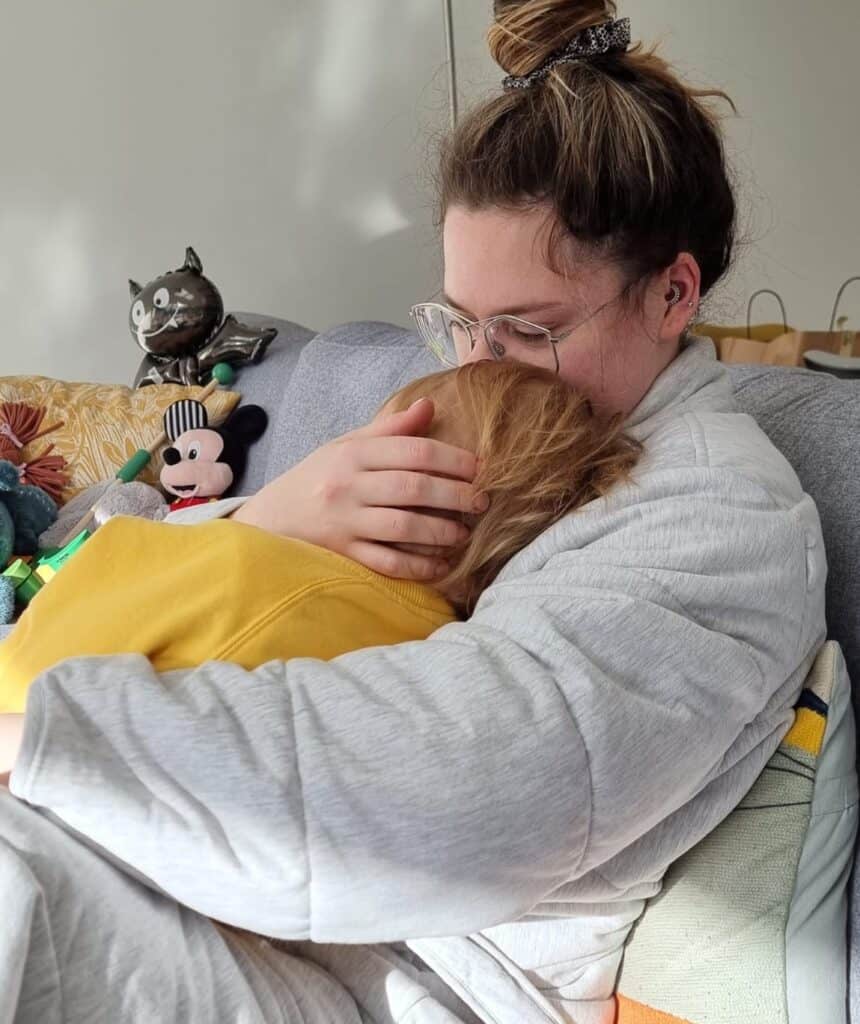 Female cuddling child