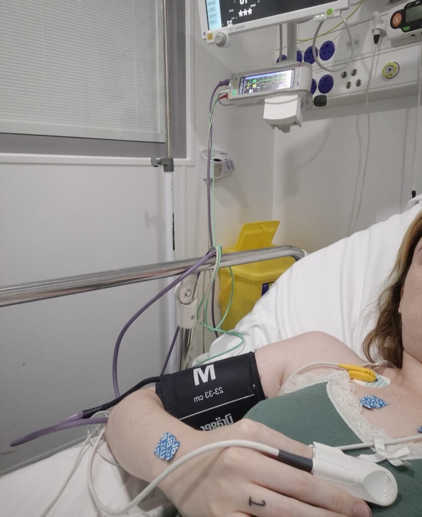Female lying in hospital bed