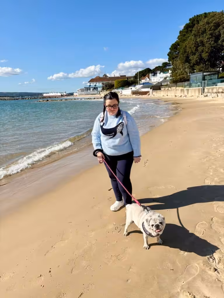 Tasmin on beach walking dog