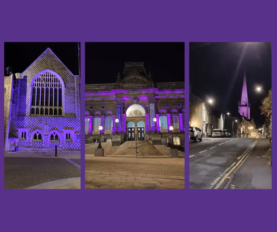 3 buildings lit up purple